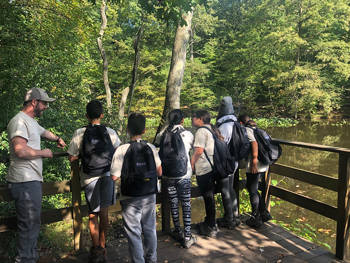 Five kids admire the trees at the Staten Island Greenbelt